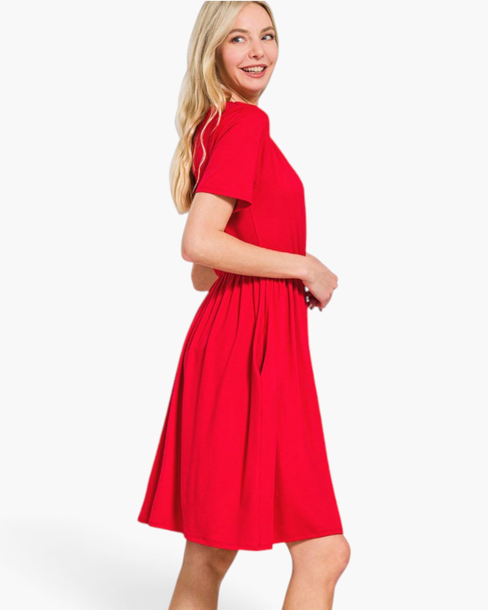 A woman modeling a bright red short-sleeve midi dress with a gathered waist and flared skirt, photographed against a clean white studio background.