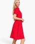 A woman modeling a bright red short-sleeve midi dress with a gathered waist and flared skirt, photographed against a clean white studio background.