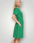 Woman wearing a green dress against a white background