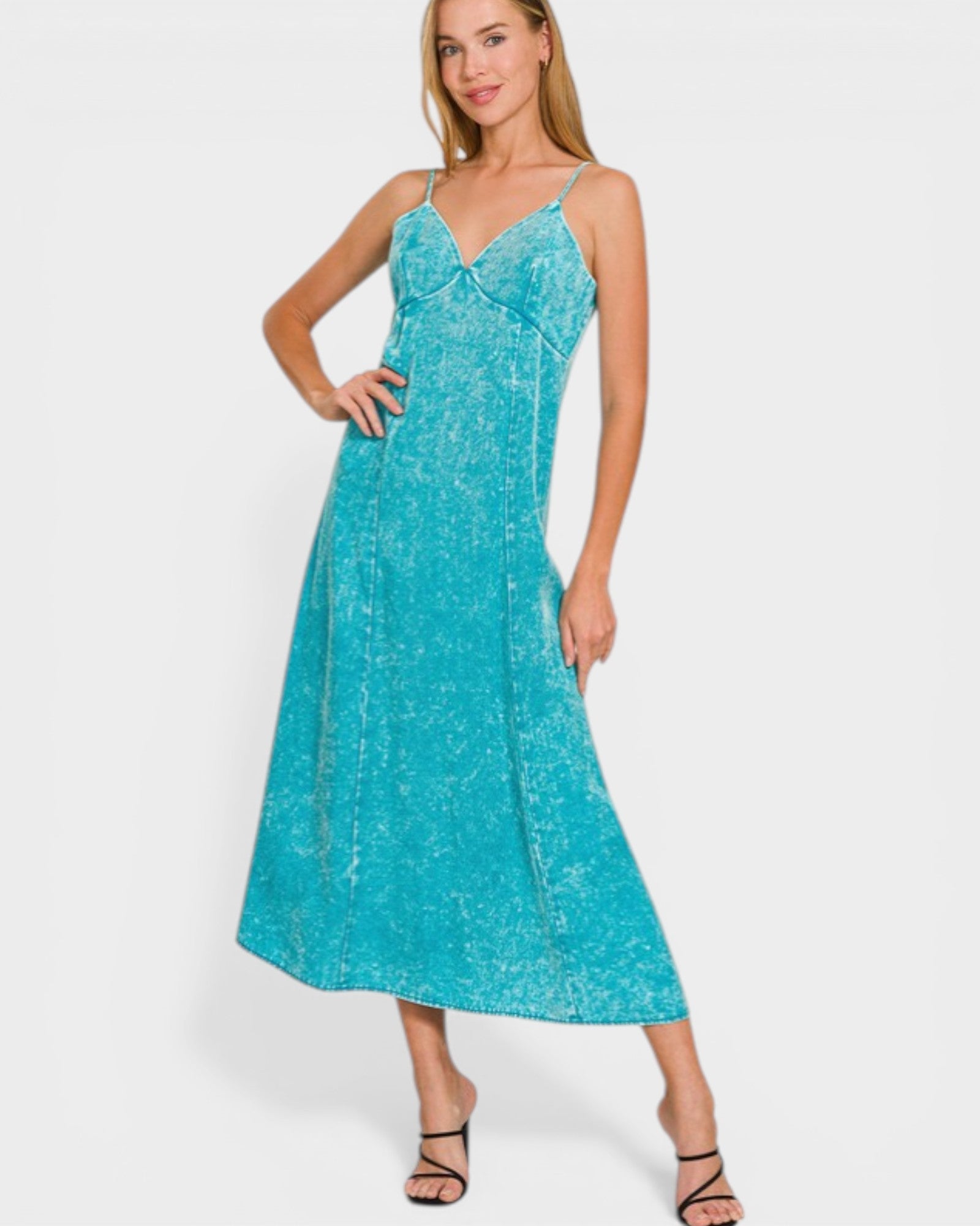 Woman wearing a turquoise dress on a white background