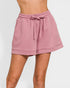 Pink shorts with a drawstring on a white background