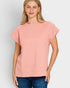 Woman wearing a pink textured top against a light gray background