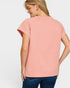 Woman wearing a pink short-sleeve top on a white background