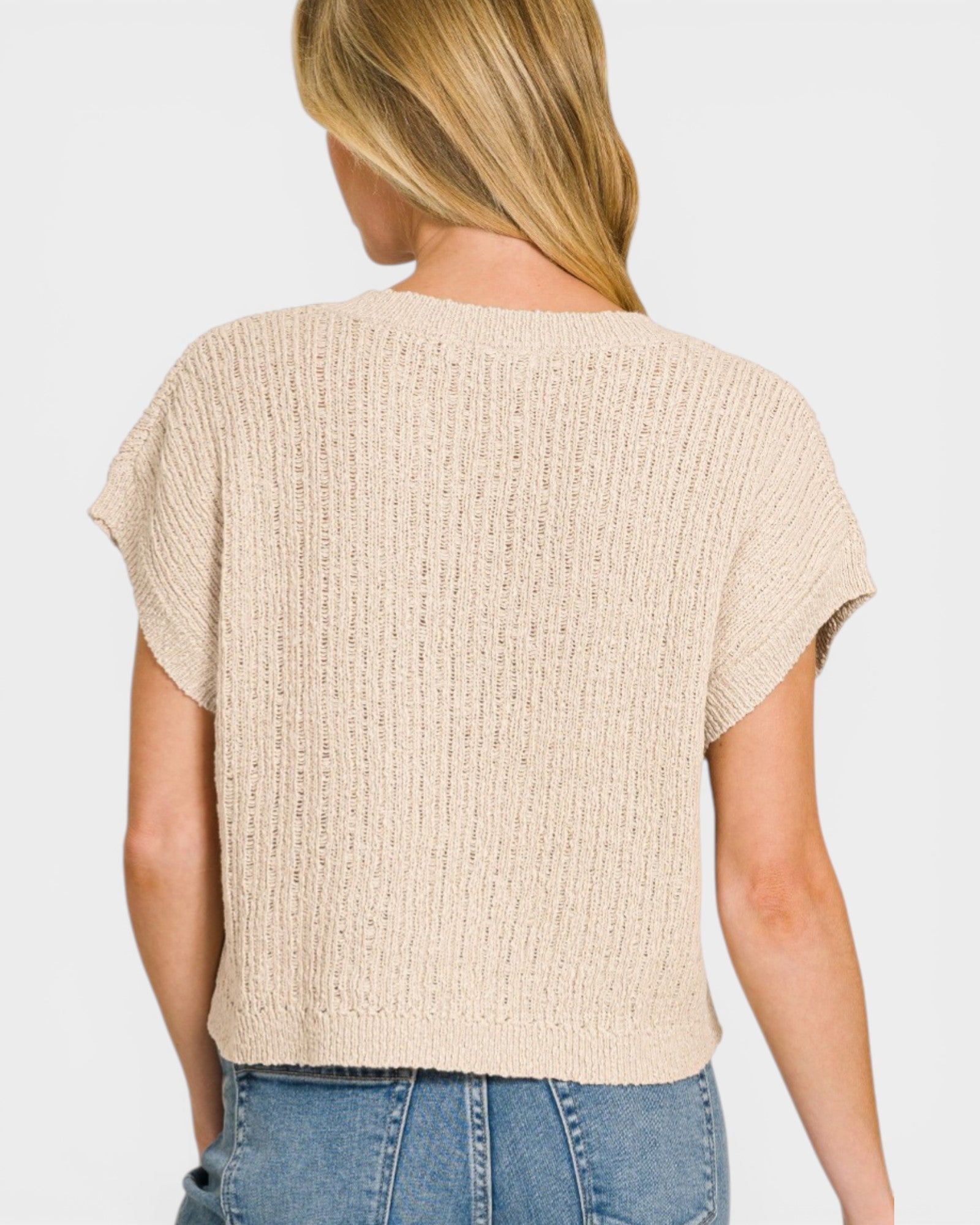 Beige textured top worn by a person on a plain background
