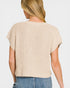 Beige textured top worn by a person on a plain background