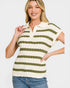 Woman wearing a green and white striped shirt on a plain background