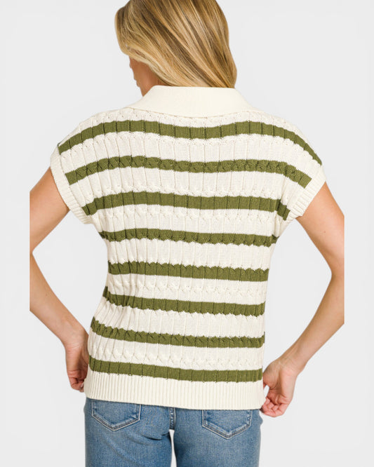 Woman wearing a green and white striped sweater vest on a white background
