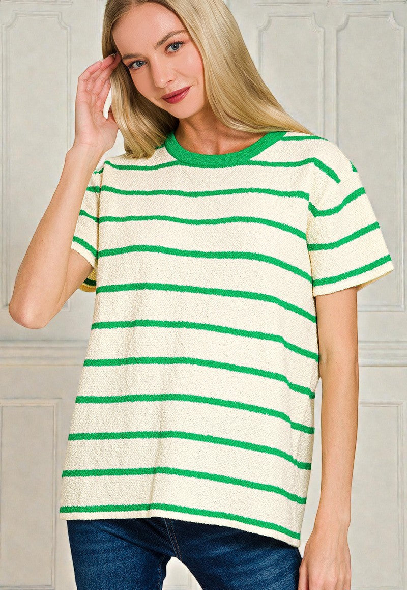 Woman wearing a green and white striped shirt against a neutral background