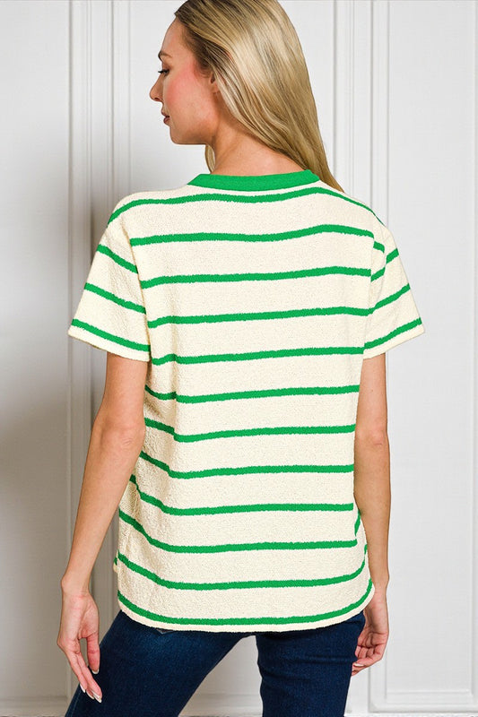 Person wearing a green and white striped shirt against a plain background