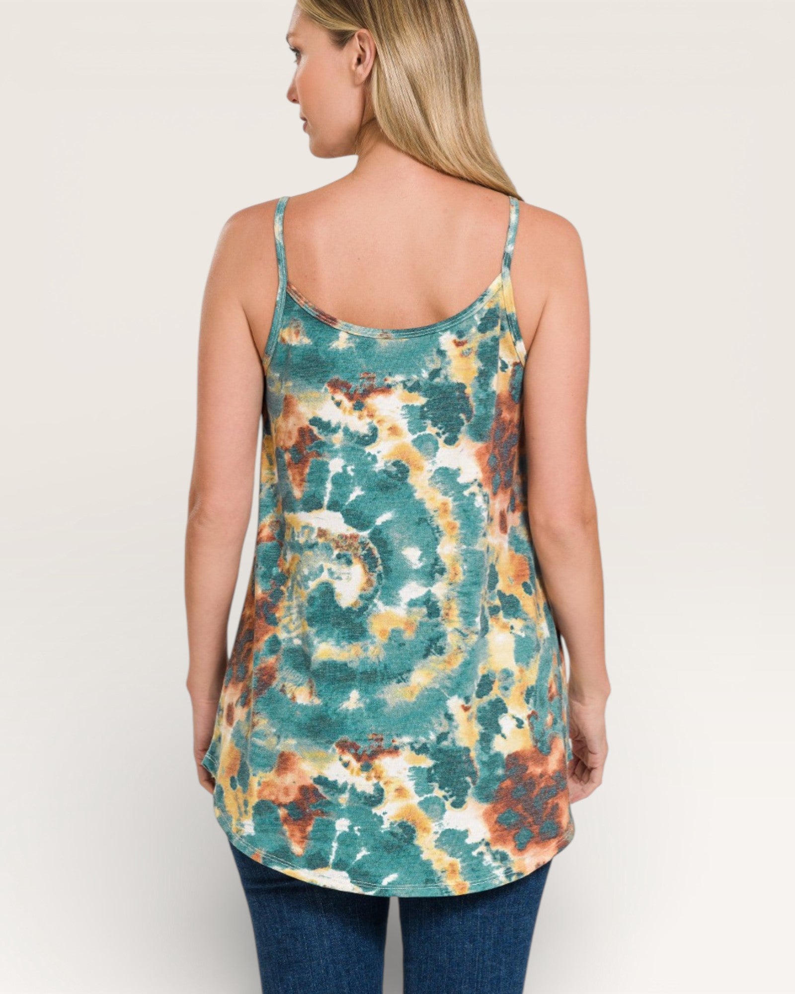 Woman wearing a tie-dye tank top with a neutral background