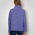 Person wearing a purple long-sleeve shirt against a plain background