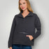 Woman wearing a dark gray pullover with a zipper pocket on a light gray background