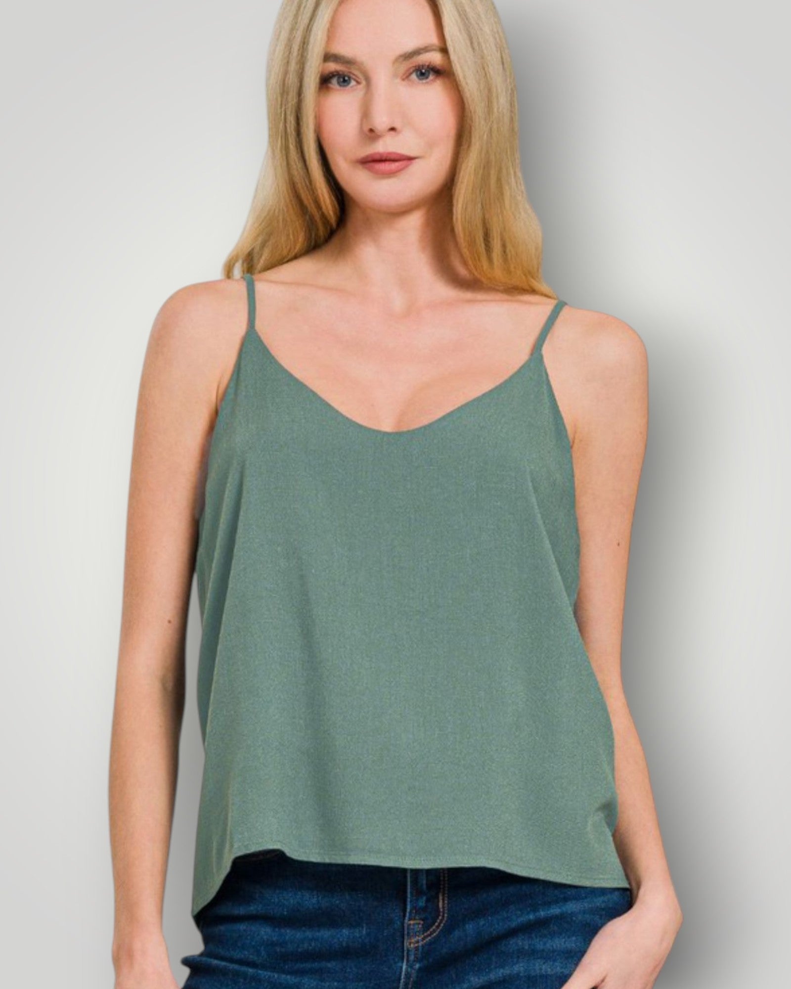 Woman wearing a green tank top against a plain background