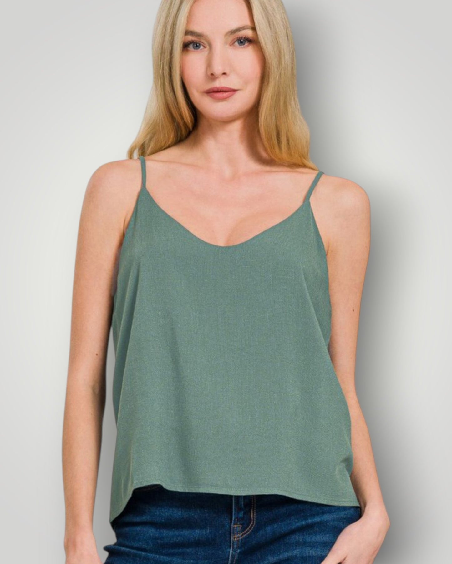 Woman wearing a green tank top against a plain background