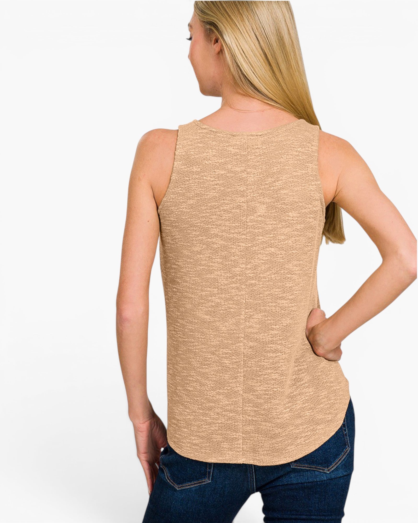 A woman shown from the back wearing a sleeveless heathered beige top and dark blue jeans against a plain white studio background.