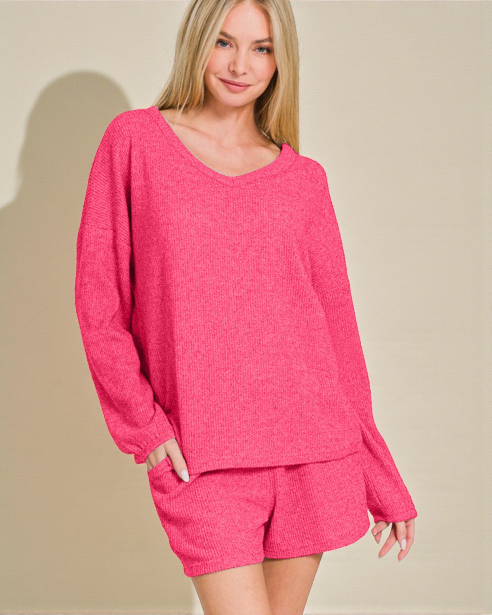 Woman wearing a pink outfit with a plain background