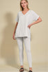 Woman wearing a white outfit on a beige background