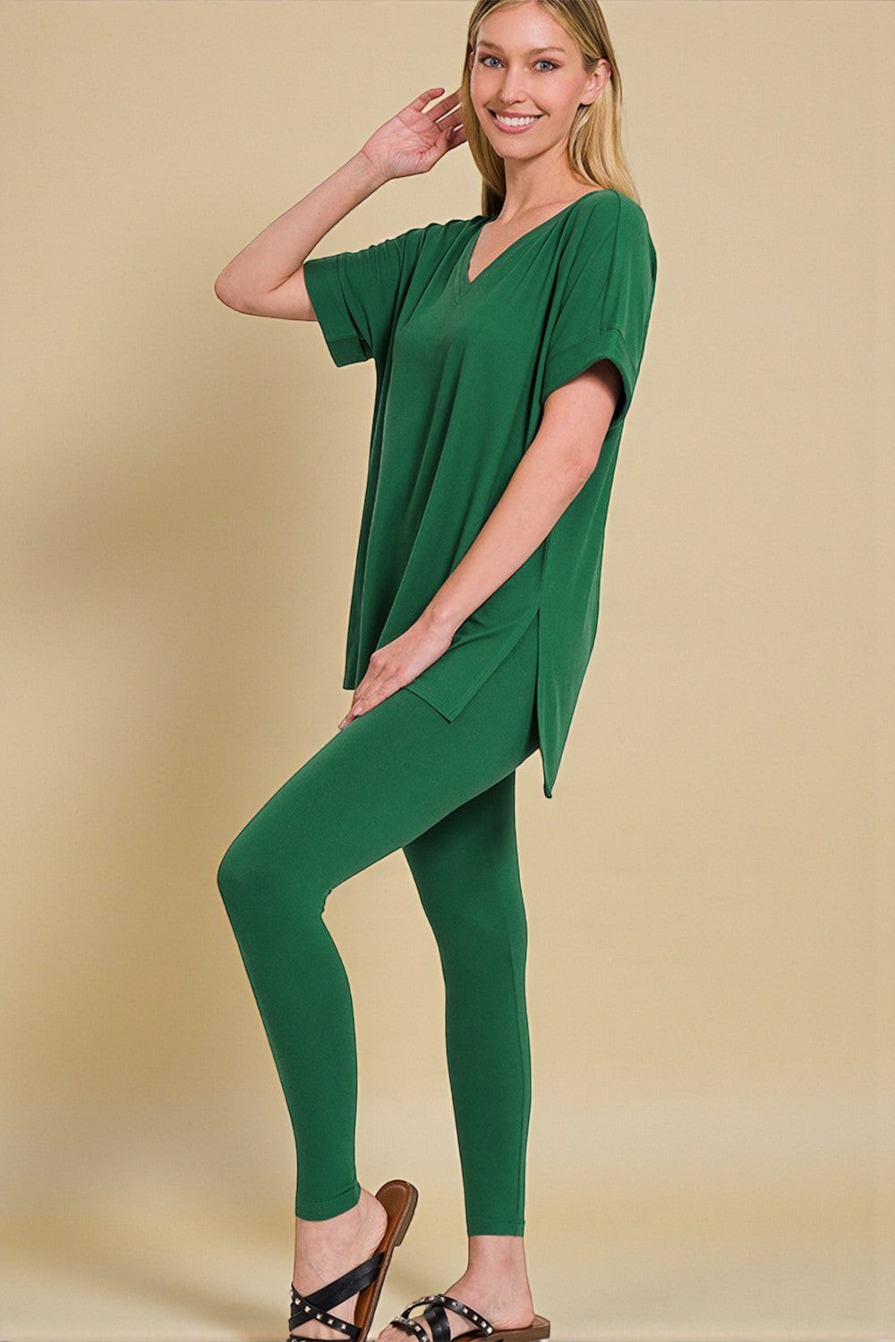 Woman wearing a green outfit on a beige background
