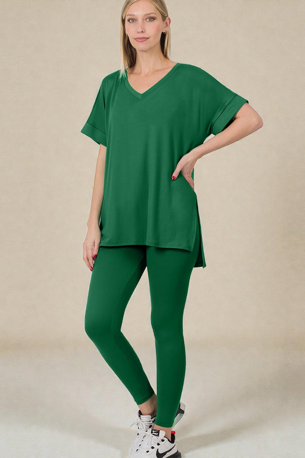 Woman wearing a green outfit on a beige background