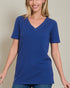 Woman wearing a blue t-shirt against a plain background