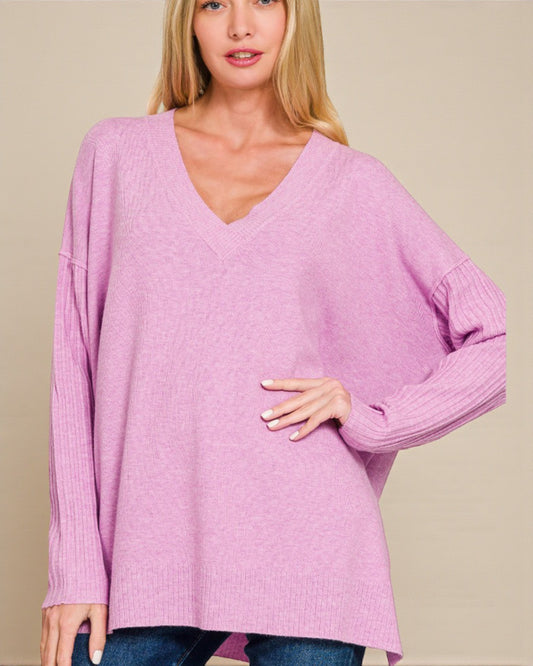 Woman wearing a pink sweater against a beige background