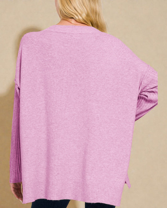Pink cardigan worn by a person on a beige background