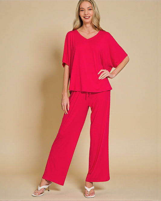 Woman wearing a red outfit on a beige background