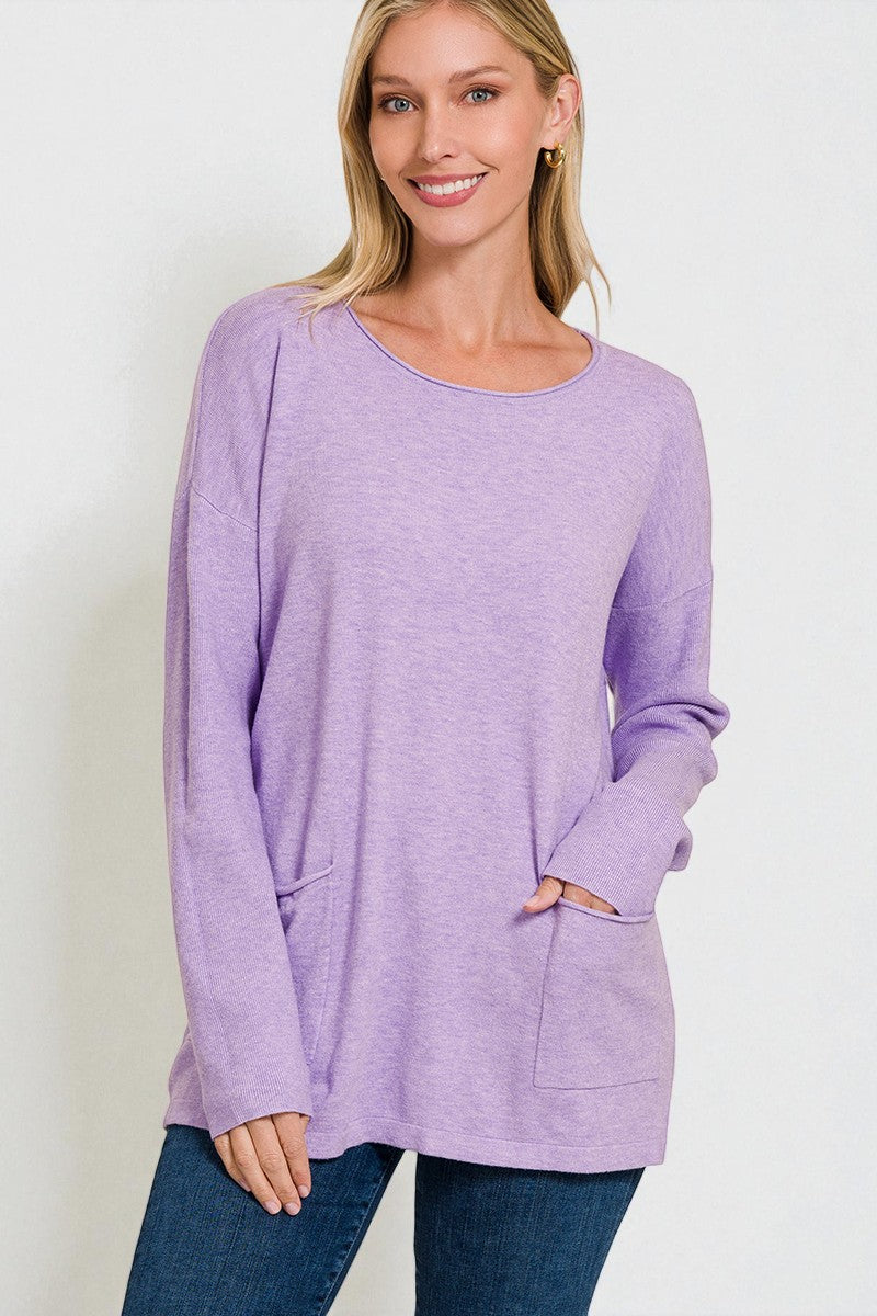 Woman wearing a purple sweater with a plain background