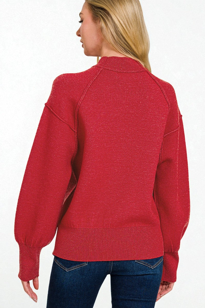 Red sweater worn by a person on a white background