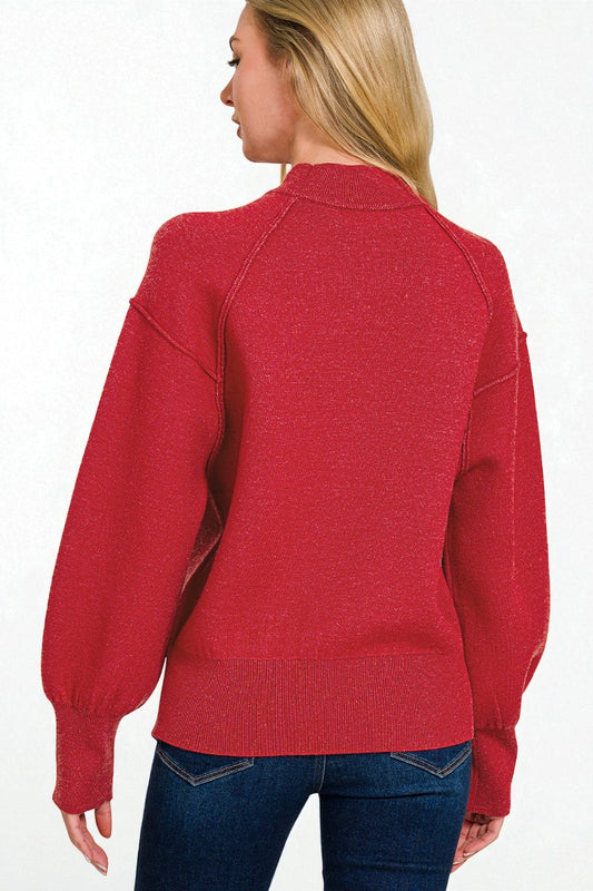Red sweater worn by a person on a white background