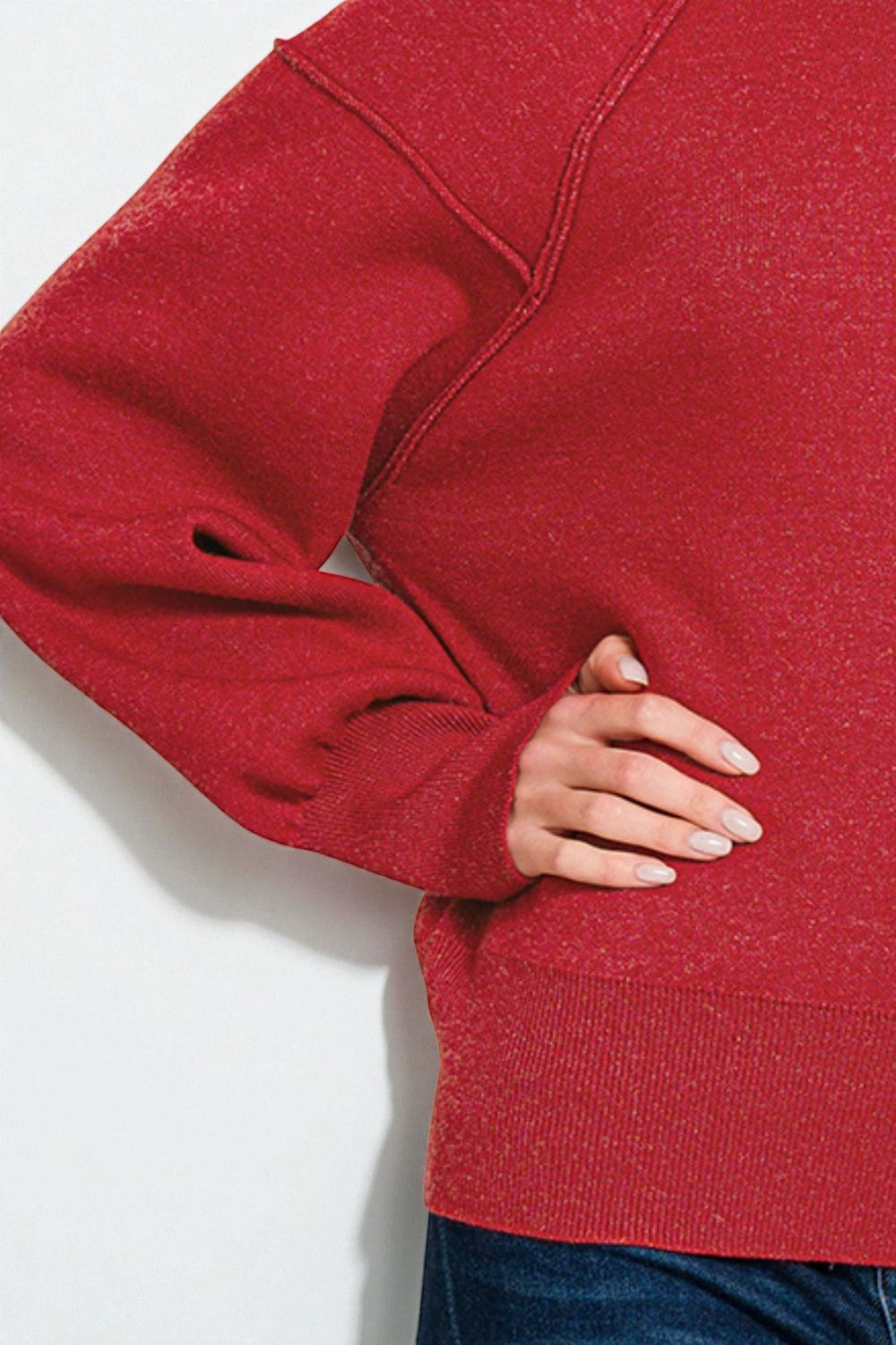 Red sweater worn by a person on a white background