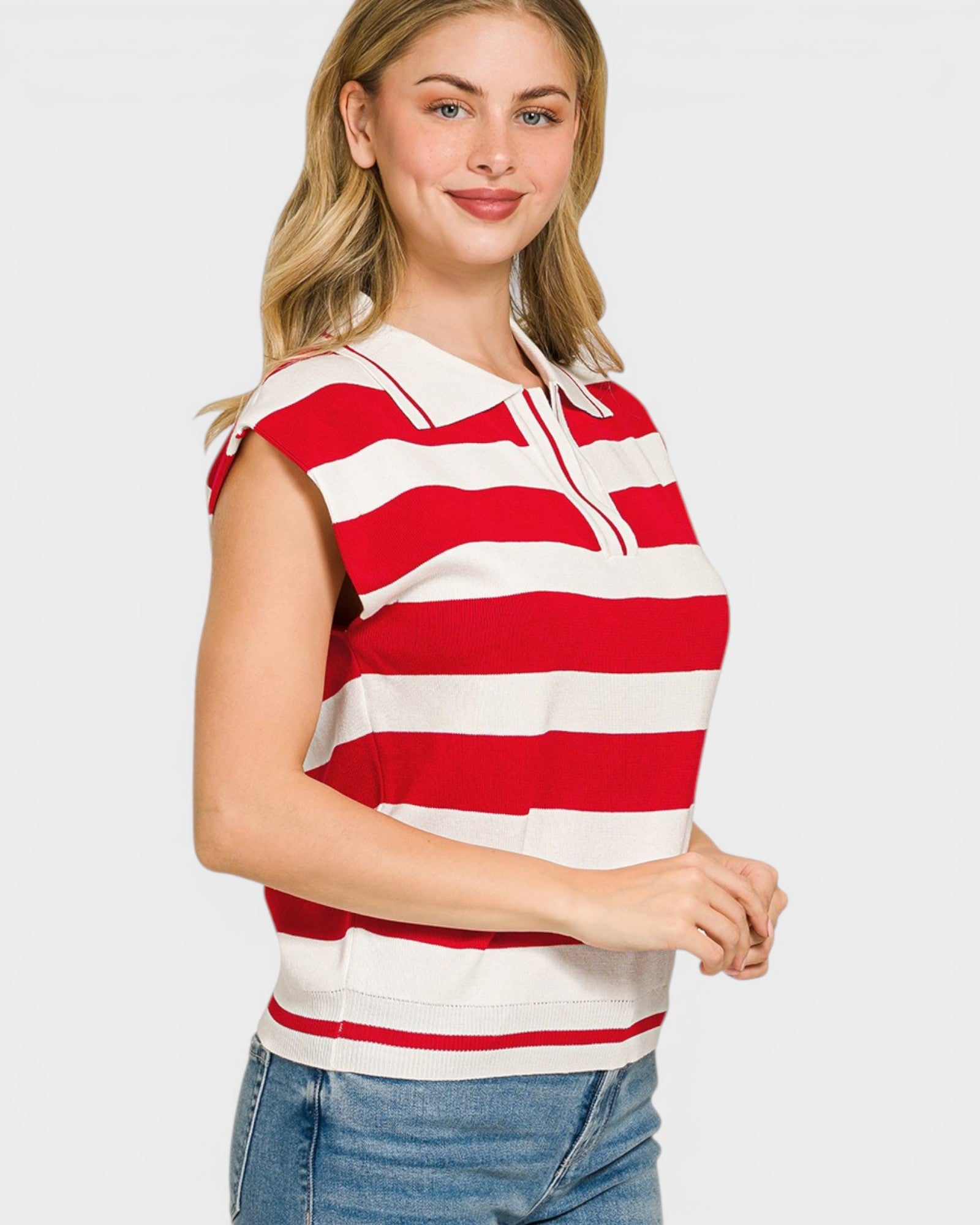 Woman wearing a red and white striped sleeveless top on a plain background