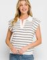 Woman wearing a white and black striped shirt with a plain background