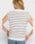 Person wearing a white and black striped shirt on a plain background