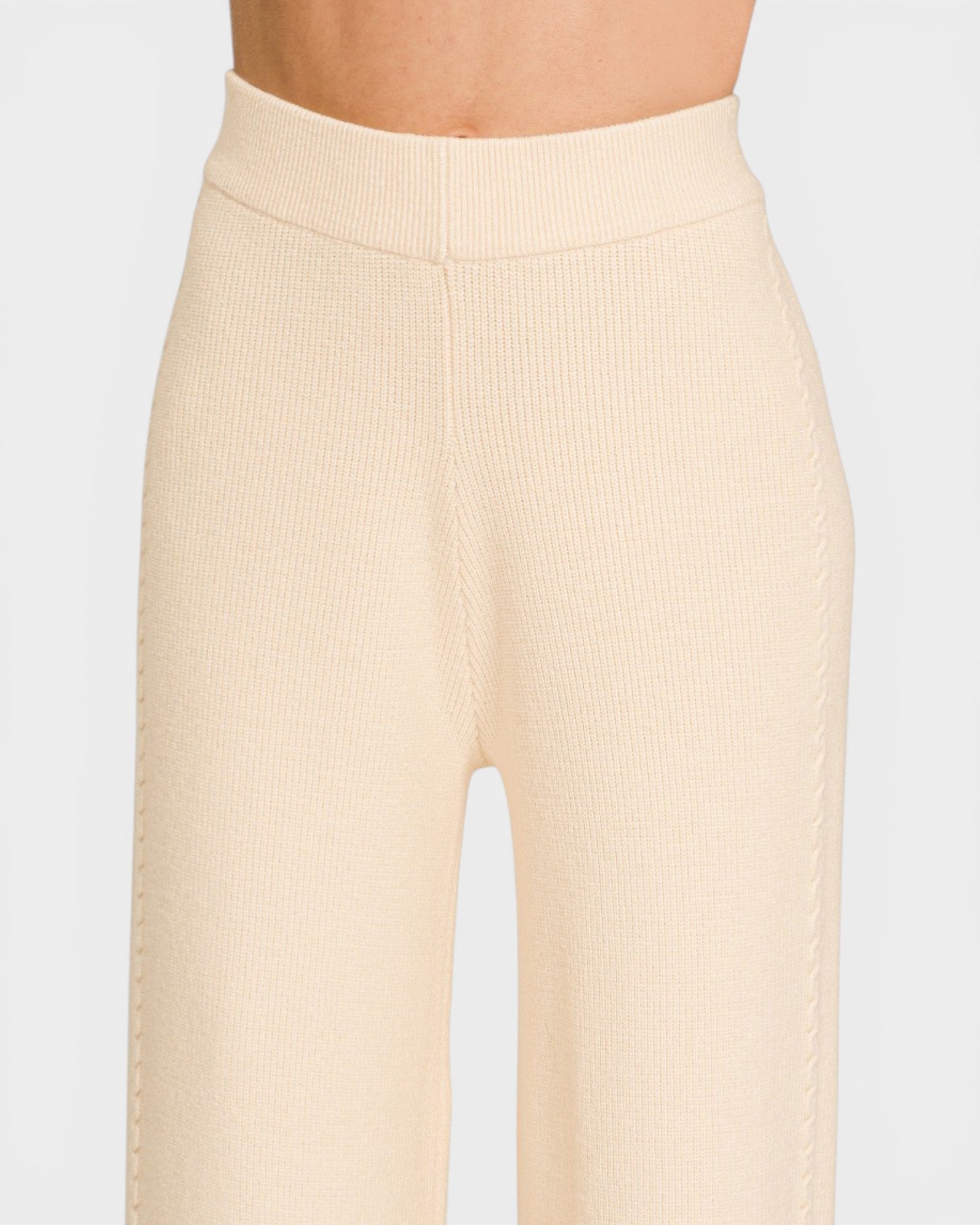 Beige ribbed pants on a white background
