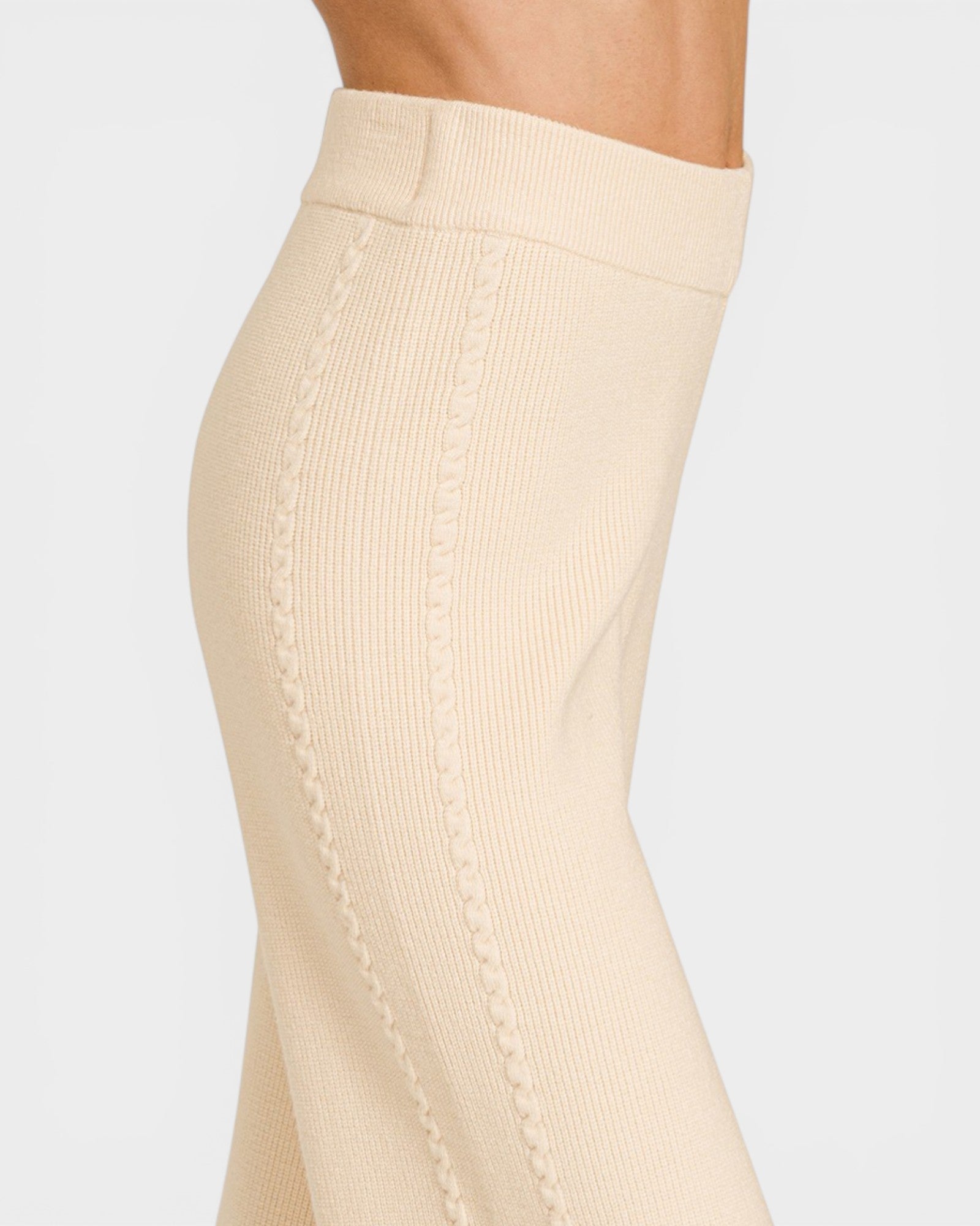 Beige ribbed leggings worn by a person on a light gray background