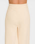 Beige ribbed pants on a plain background