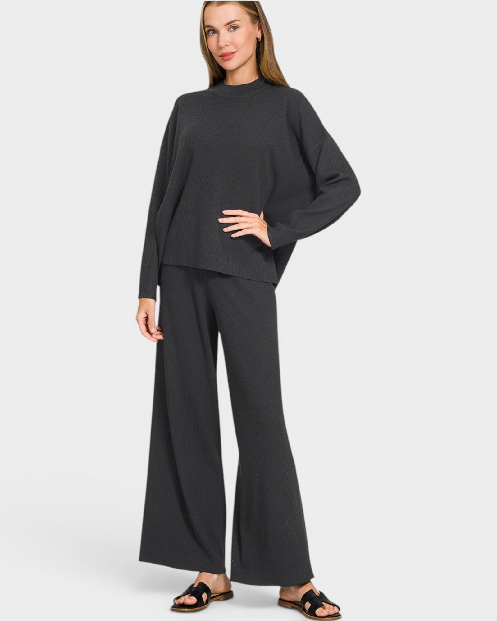 Woman wearing a black outfit on a white background
