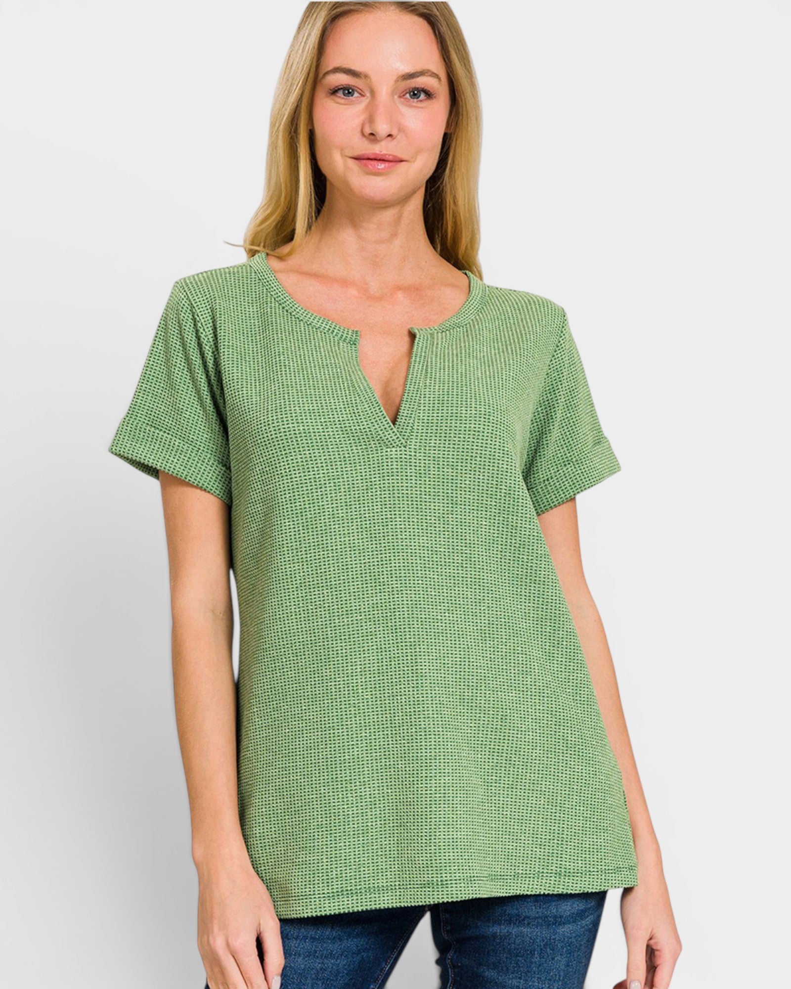Woman wearing a green checkered top on a white background