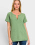Woman wearing a green checkered top on a white background
