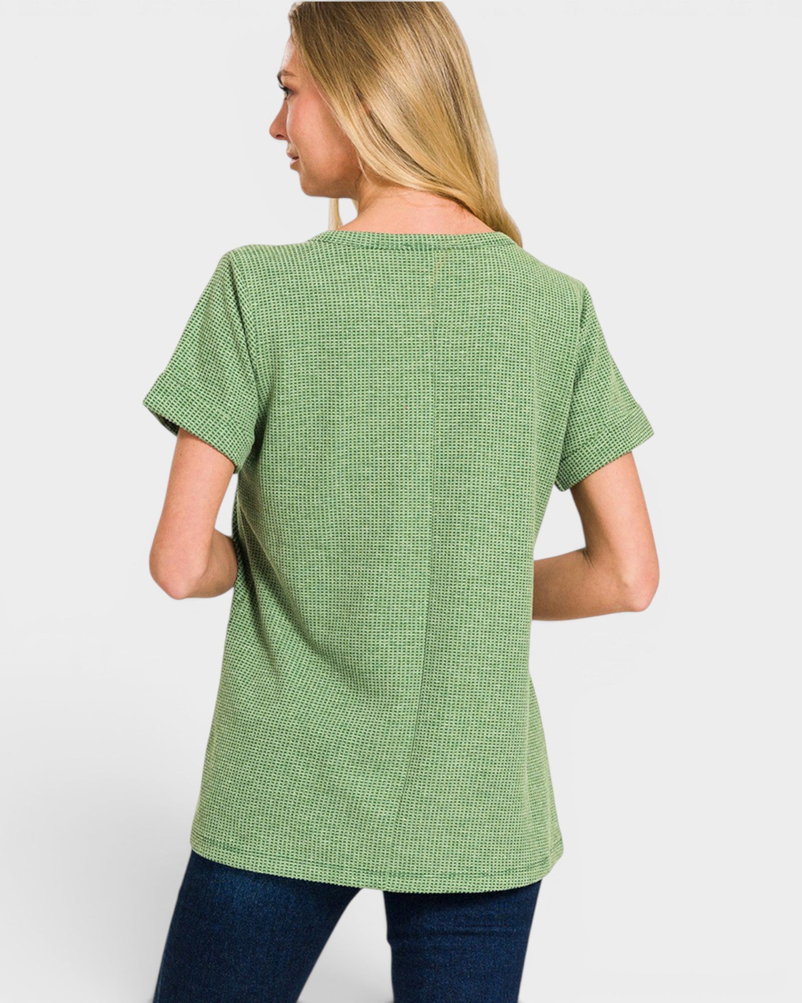 Person wearing a green textured t-shirt on a white background