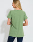 Woman wearing a green textured t-shirt against a white background
