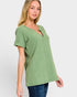 Woman wearing a green textured top on a white background
