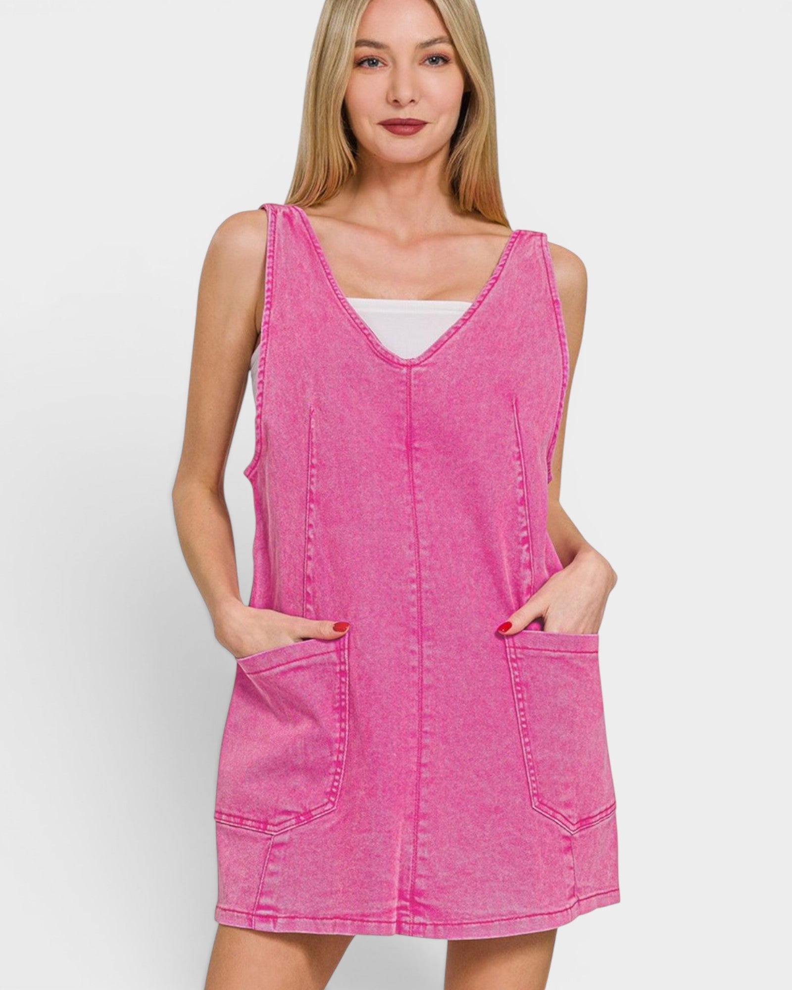 Woman wearing a pink sleeveless dress against a white background