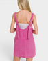 Pink denim dress worn by a person on a white background