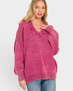 Woman wearing a pink sweater on a white background