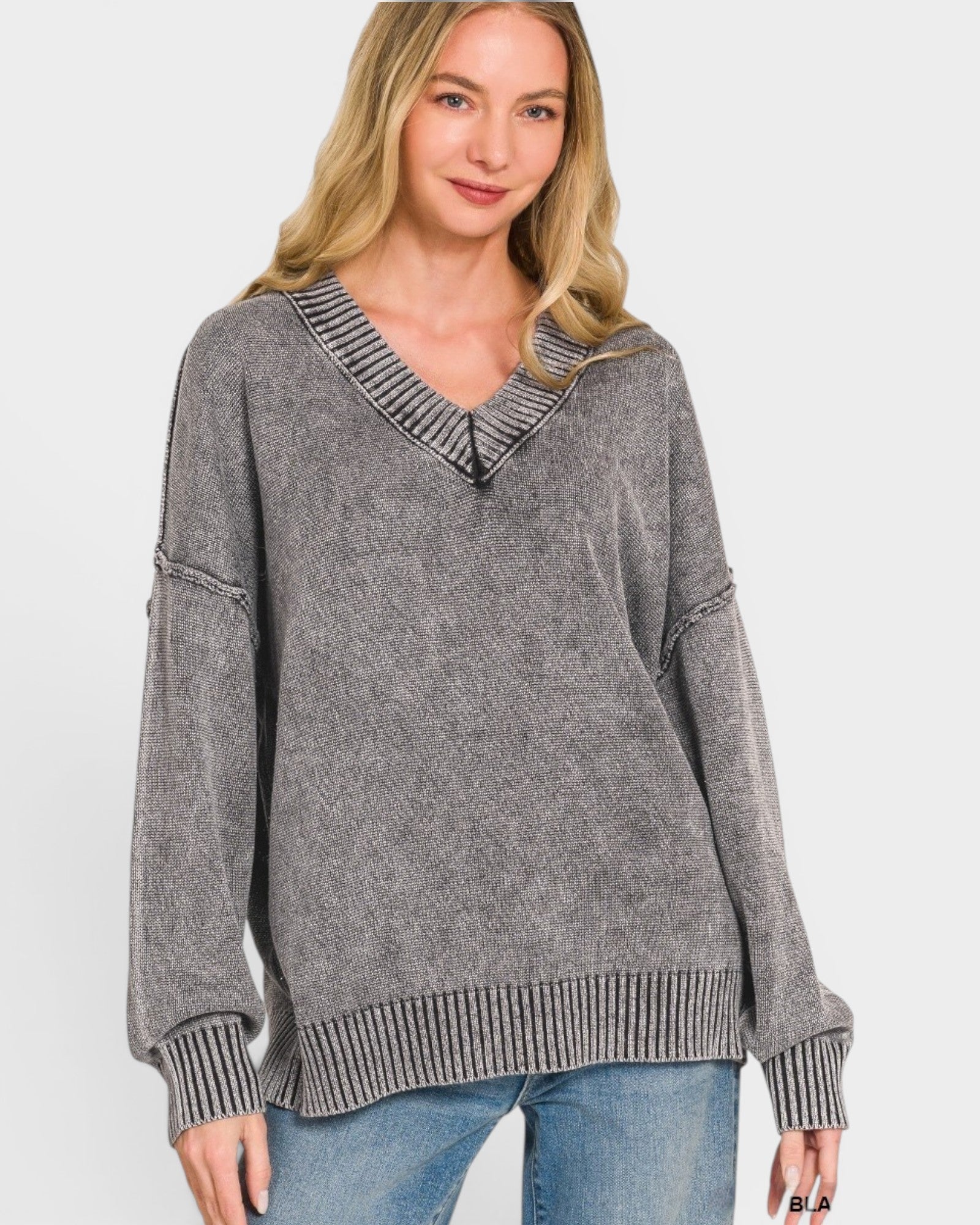Woman wearing a gray sweater with a textured collar on a white background
