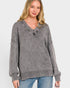 Woman wearing a gray sweater with a textured collar on a white background