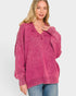 Woman wearing a pink sweater on a white background