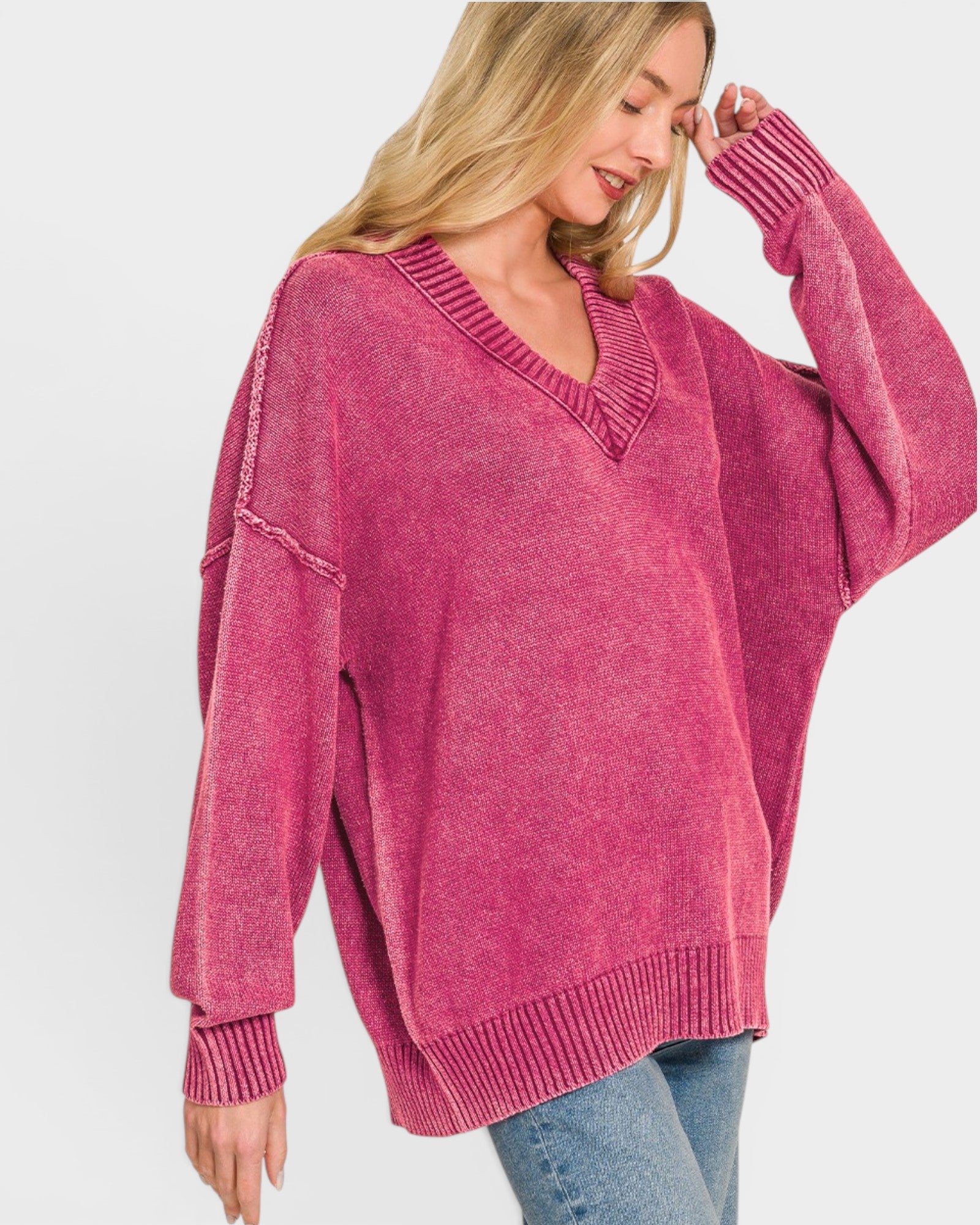 Woman wearing a pink sweater on a white background